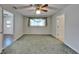 Bright bedroom with green carpet, ceiling fan, and neutral walls at 622 Jamaica Cir, Lakeland, FL 33803