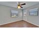 Bedroom with wood flooring, ceiling fan, and windows with blinds at 622 Jamaica Cir, Lakeland, FL 33803