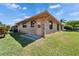 Backside of brick home with green lawn at 622 Jamaica Cir, Lakeland, FL 33803