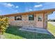 Side view of brick home with a lush green lawn at 622 Jamaica Cir, Lakeland, FL 33803