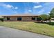 Side view of brick home with manicured lawn at 622 Jamaica Cir, Lakeland, FL 33803