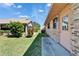 Side yard of brick house with lush grass and tropical foliage at 622 Jamaica Cir, Lakeland, FL 33803