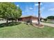Landscaped front lawn with palm tree, brick driveway, and charming one-story home at 622 Jamaica Cir, Lakeland, FL 33803