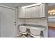 Close-up of the kitchen workspace, with 2 chairs and kitchen cabinets at 622 Jamaica Cir, Lakeland, FL 33803