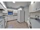Spacious kitchen with white appliances and adjacent built in workspace at 622 Jamaica Cir, Lakeland, FL 33803