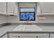 Close-up of the double kitchen sink with backyard view at 622 Jamaica Cir, Lakeland, FL 33803