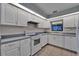 Functional kitchen featuring white appliances, tile floor, and a window view at 622 Jamaica Cir, Lakeland, FL 33803
