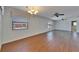 Bright living area featuring laminate floors, two windows and a ceiling fan at 622 Jamaica Cir, Lakeland, FL 33803