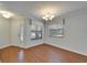 Living room area showcasing laminate floors, a decorative chandelier and a stained-glass window accent at 622 Jamaica Cir, Lakeland, FL 33803