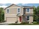 Charming two-story home with a two-car garage and a welcoming front entrance at 2402 Slippery Rock St, Auburndale, FL 33823