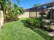 Backyard featuring a screened patio and tropical landscaping, great for privacy and outdoor enjoyment at 8212 Borgia Ct, Orlando, FL 32836