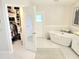 Stylish bathroom featuring a standalone soaking tub, modern finishes, a walk-in closet, and lots of storage at 8212 Borgia Ct, Orlando, FL 32836