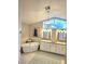 Bright bathroom features a soaking tub, chandelier, and double vanity with ample counter space at 8212 Borgia Ct, Orlando, FL 32836
