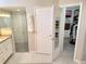 Bathroom view showing glass-enclosed shower and walk-in closet for convenient access and storage at 8212 Borgia Ct, Orlando, FL 32836