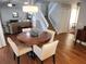 Open dining area with hardwood floors and a view of the staircase and living room at 8212 Borgia Ct, Orlando, FL 32836
