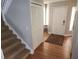Inviting entryway with hardwood floors, coat closet, and staircase at 8212 Borgia Ct, Orlando, FL 32836