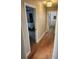Hallway with wood floors leading to bedrooms, showing ample natural light at 8212 Borgia Ct, Orlando, FL 32836