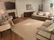 Cozy living room with stone fireplace and comfortable seating on the hardwood flooring at 8212 Borgia Ct, Orlando, FL 32836