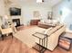 Bright living room featuring a stone fireplace, hardwood floors, and comfortable seating arrangement at 8212 Borgia Ct, Orlando, FL 32836