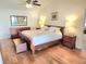 Spacious main bedroom suite featuring hardwood floors, a ceiling fan, and lots of natural light at 8212 Borgia Ct, Orlando, FL 32836