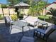 A covered patio features comfortable outdoor seating and a table for outdoor dining or relaxing at 8212 Borgia Ct, Orlando, FL 32836