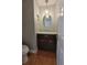 Powder room featuring a decorative mirror and chandelier for a touch of elegance at 8212 Borgia Ct, Orlando, FL 32836