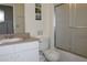 Well-maintained bathroom with a single sink vanity, toilet, and shower with a glass door at 151 Pompano Beach Dr, Kissimmee, FL 34746