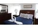 Comfortable bedroom featuring a queen bed, swan towel art, dresser and side tables at 151 Pompano Beach Dr, Kissimmee, FL 34746