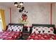 Themed bedroom with two beds, Mickey Mouse bedding, and a playful wall mural for a fun retreat at 151 Pompano Beach Dr, Kissimmee, FL 34746