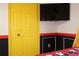 Themed bedroom with red and black accents, bright yellow closet door, and a playful Mickey Mouse mural at 151 Pompano Beach Dr, Kissimmee, FL 34746