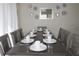 Charming dining area with a rustic wood table set for a meal, complemented by decorative wall art at 151 Pompano Beach Dr, Kissimmee, FL 34746
