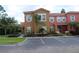 Inviting townhome with colorful exteriors, landscaped front, and designated parking in front at 151 Pompano Beach Dr, Kissimmee, FL 34746