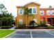 Beautiful two-story townhome with lush landscaping and a vibrant exterior at 151 Pompano Beach Dr, Kissimmee, FL 34746