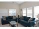 Bright living room featuring neutral walls, tile flooring, and comfortable seating with plenty of natural light at 151 Pompano Beach Dr, Kissimmee, FL 34746