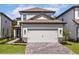 Charming two-story home with neutral exterior and a spacious two-car garage at 7705 Somersworth Dr, Kissimmee, FL 34747