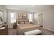 Relaxing main bedroom featuring neutral paint, carpeted floor, two windows, and an ensuite bathroom at 4047 Gardenia Ave, Lake Hamilton, FL 33851