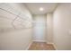 Walk-in closet features carpet flooring and extensive shelving for optimal storage and organization at 4047 Gardenia Ave, Lake Hamilton, FL 33851
