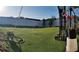 Spacious backyard with an artificial grass lawn and a white fence surrounding the property at 210 Cheshire Way, Davenport, FL 33897