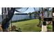 Spacious backyard with an artificial grass lawn and a white fence surrounding the property at 210 Cheshire Way, Davenport, FL 33897