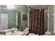 Bathroom featuring a decorative shower curtain and vanity with a large mirror at 210 Cheshire Way, Davenport, FL 33897