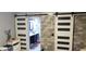 Bedroom with a view to the en-suite bath behind sliding barn doors at 210 Cheshire Way, Davenport, FL 33897