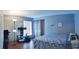 Charming bedroom with wood floors, neutral walls, and a decorative floor lamp at 210 Cheshire Way, Davenport, FL 33897