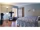 Cozy bedroom featuring calming colors, closet, and dark wood floors at 210 Cheshire Way, Davenport, FL 33897