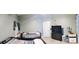 Bedroom with two beds, light grey walls, and wood-look laminate flooring at 210 Cheshire Way, Davenport, FL 33897