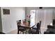 Bright dining area with a wooden table set next to a sliding glass door to the backyard at 210 Cheshire Way, Davenport, FL 33897
