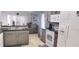 Bright kitchen with stone backsplash, stainless appliances, granite countertop, breakfast nook, and tile floor at 210 Cheshire Way, Davenport, FL 33897