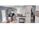 Bright eat-in kitchen with stainless steel appliances, tile flooring, and lots of cabinets at 210 Cheshire Way, Davenport, FL 33897