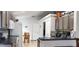 Bright kitchen featuring stone backsplash, stainless appliances, breakfast nook, granite countertop, and tile floor at 210 Cheshire Way, Davenport, FL 33897