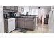 Bright kitchen featuring stone backsplash, stainless appliances, granite countertop, breakfast nook, and tile floor at 210 Cheshire Way, Davenport, FL 33897