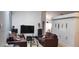 Open living room featuring comfortable seating, entertainment center, and bright light at 210 Cheshire Way, Davenport, FL 33897